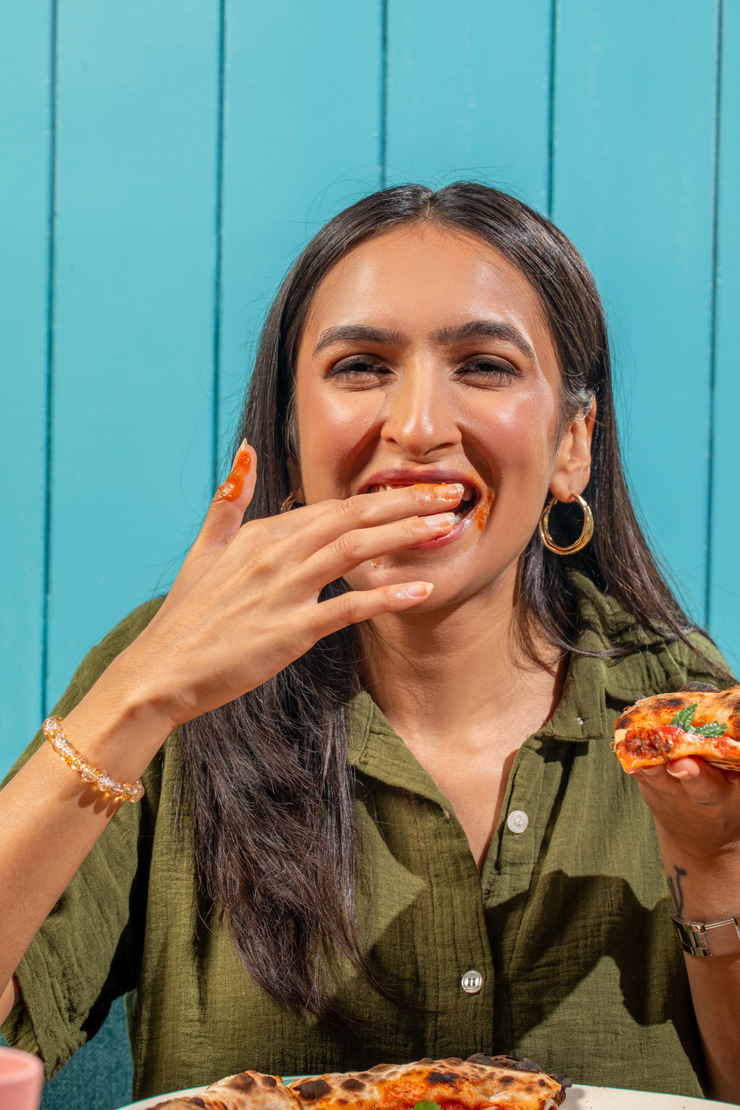 A guest enjoying pizza at Serious Slice